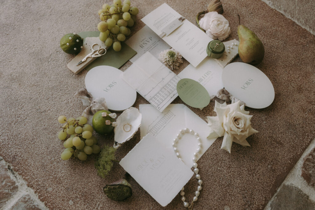 Flatlay with jewelry and invites, styled by fine art wedding photographer Spain