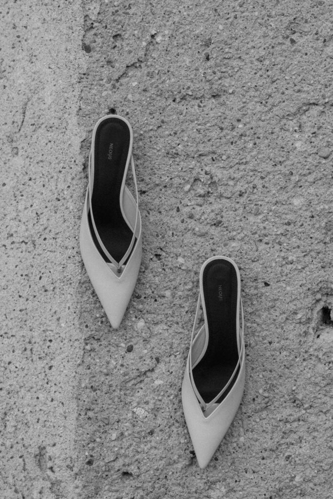 Minimalist bridal shoes on stone floor by Spain-based wedding photographer