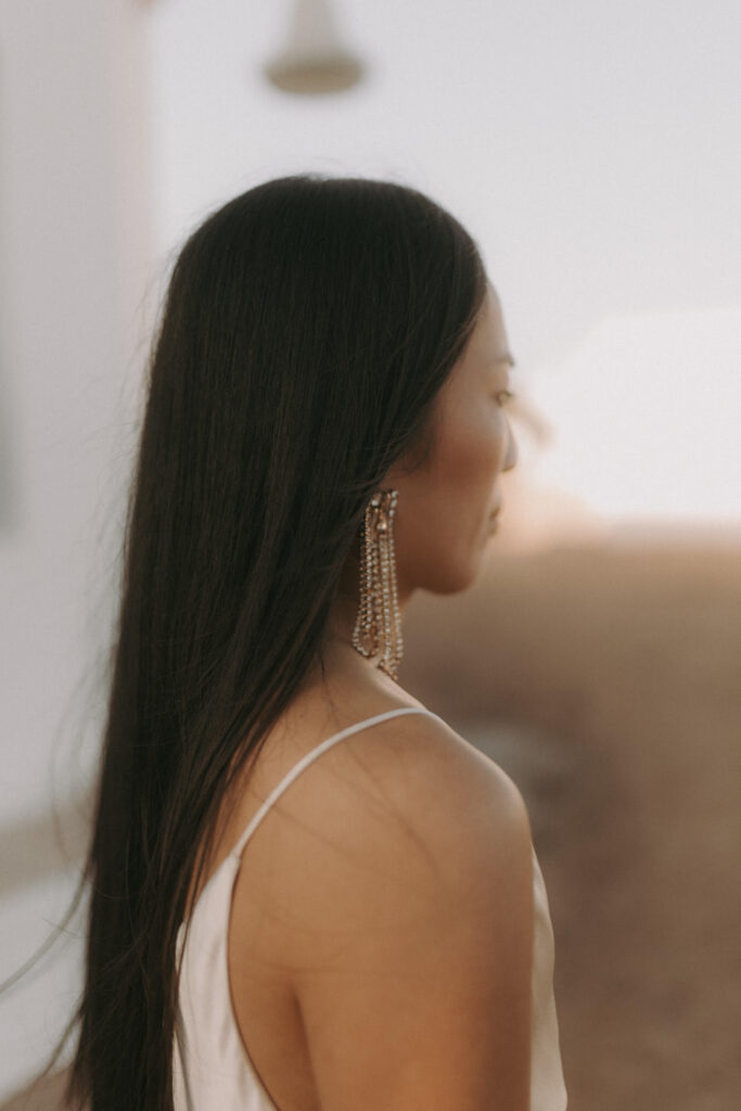 Elegant bridal portrait with statement earrings in Spain