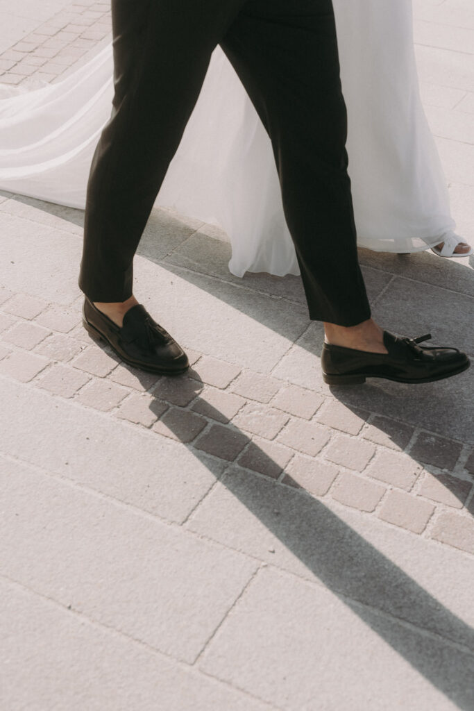 Bride and groom walking through Spanish town – candid street wedding photo