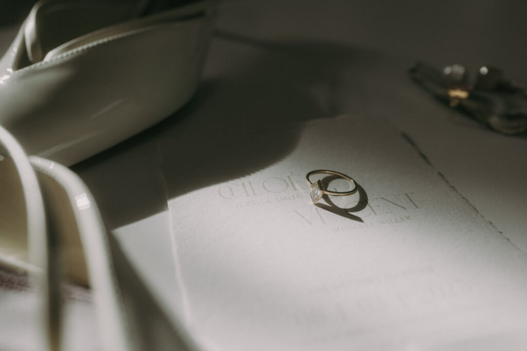 Engagement ring in soft light on invite, captured by wedding photographer in Spain