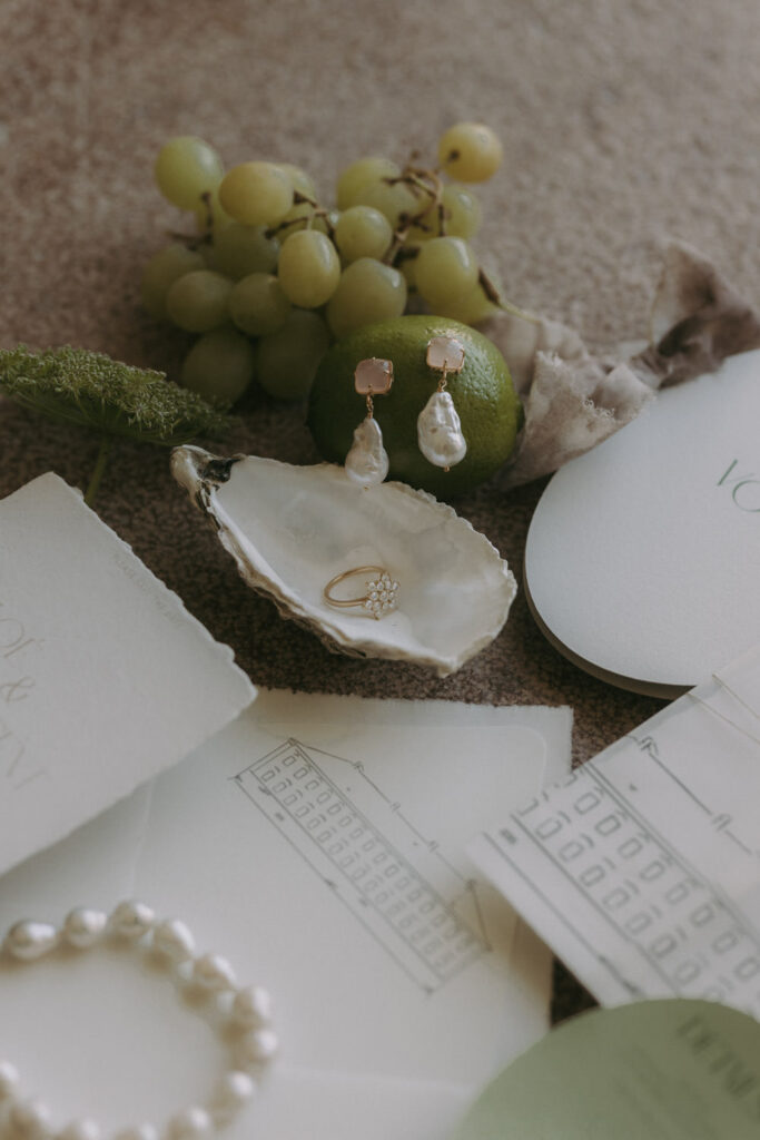 Wedding details flatlay with ring and grapes by wedding photographer Spain
